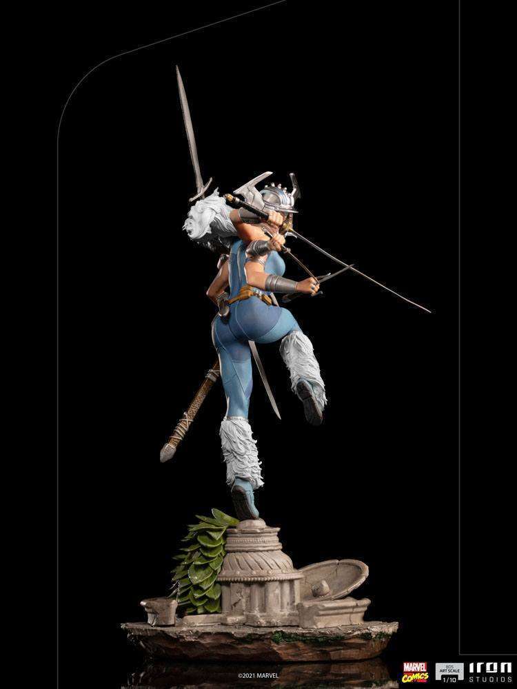 Rear view of Iron Studios Spiral 1/10 scale statue featuring six arms, swords, and white fur boots on a stone base.
