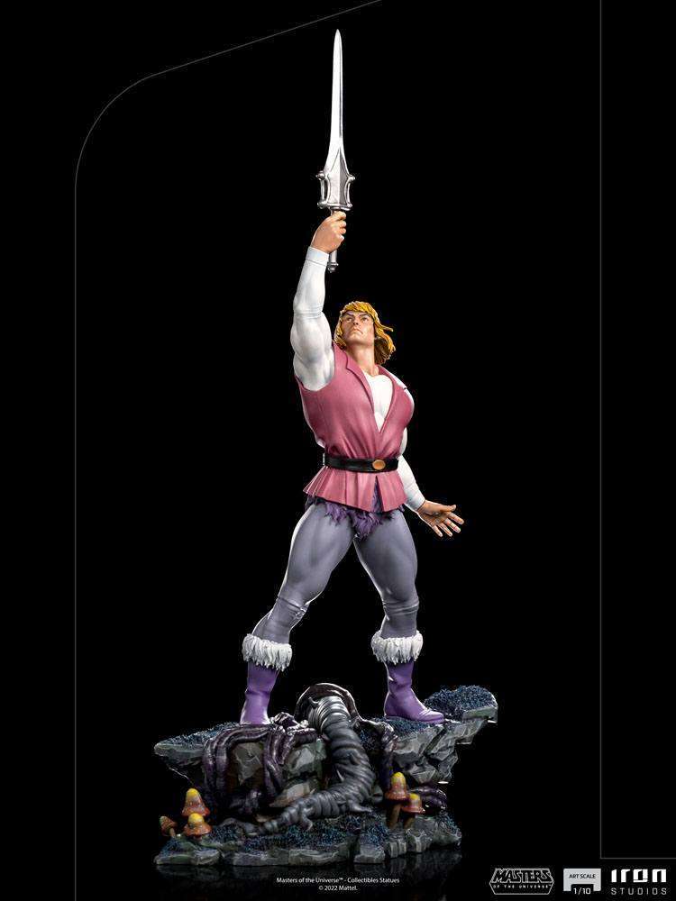 Iron Studios 1/10 Prince Adam statue from Masters of the Universe, shown from the side holding his Power Sword aloft.