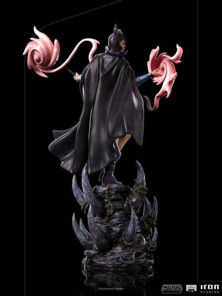 Back view of Iron Studios Evil-Lyn 1/10 scale statue with a black cape, magic effects, and rocky base.