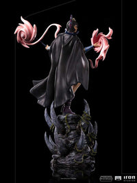 Back view of Iron Studios Evil-Lyn 1/10 scale statue with a black cape, magic effects, and rocky base.