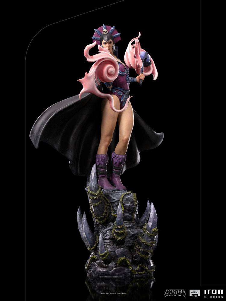 Iron Studios Evil-Lyn 1/10 scale statue in purple armor and black cape, standing on a rocky, crystal-adorned base.