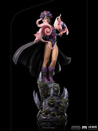 Iron Studios Evil-Lyn 1/10 scale statue in purple armor and black cape, standing on a rocky, crystal-adorned base.