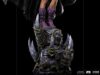 Close-up of the Iron Studios Evil-Lyn 1/10 scale statue, showing purple boots standing on a jagged, vine-covered base.