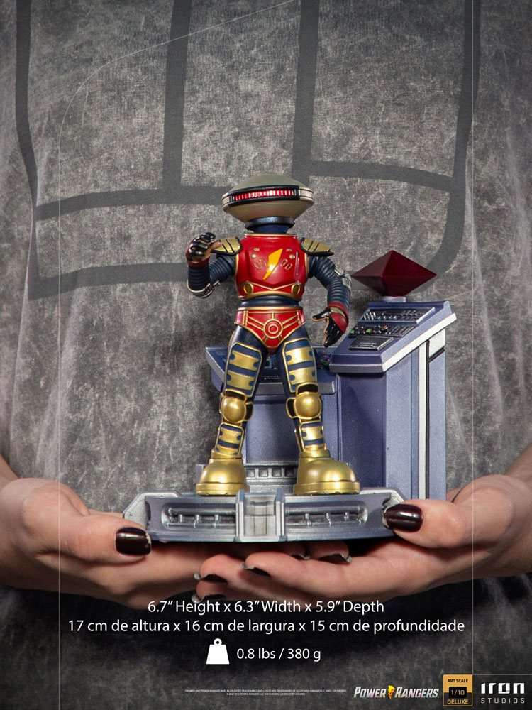 Iron Studios Alpha 5 1/10 scale statue in red and gold, standing on a command center base held in hands.