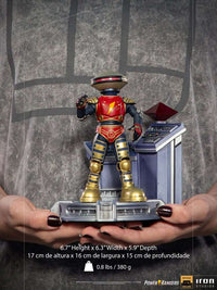 Iron Studios Alpha 5 1/10 scale statue in red and gold, standing on a command center base held in hands.