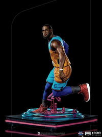 Iron Studios 1/10 LeBron James statue from Space Jam: A New Legacy, showing a side view of him in a blue and orange kit.