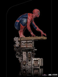 Side view of Iron Studios Spider-Man: No Way Home 1/10 scale statue crouching on a detailed industrial base.