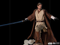 Front view of 28 cm Iron Studios Obi-Wan Kenobi statue in brown robes holding a glowing blue lightsaber.