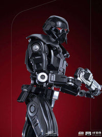 Side view of the Iron Studios 1/10 scale Dark Trooper statue featuring a glossy black finish and glowing red eyes.