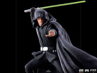 Iron Studios Luke Skywalker 1/10 scale statue in black robes with a green lightsaber in a dynamic combat pose.