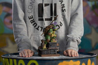 Iron Studios 1/10 scale Donatello statue featuring the turtle in a combat pose on a detailed industrial base.