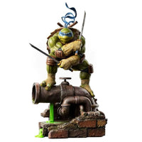 Iron Studios 1/10 scale Leonardo statue featuring the turtle in a combat pose atop a rusted pipe with green ooze.