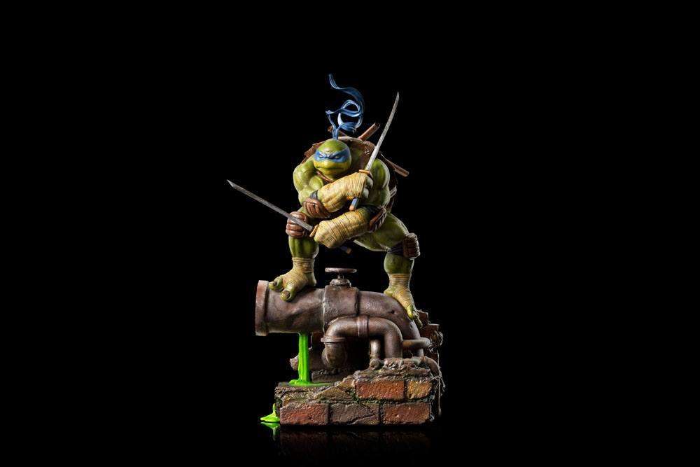 Iron Studios Leonardo 1/10 scale statue in a dynamic pose, wielding katanas atop a brick and pipe sewer base.