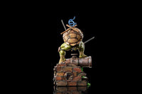 Back view of the Iron Studios Leonardo 1/10 scale statue showing his shell, katanas, and brick base on black.