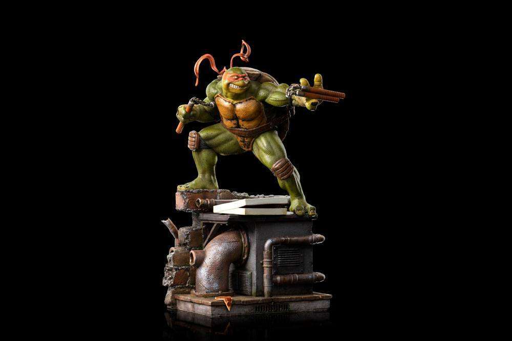 Iron Studios Michelangelo 1/10 scale statue in a dynamic pose with nunchucks atop a detailed sewer-themed display base.