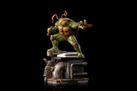 Iron Studios Michelangelo 1/10 scale statue in a dynamic pose with nunchucks atop a detailed sewer-themed display base.