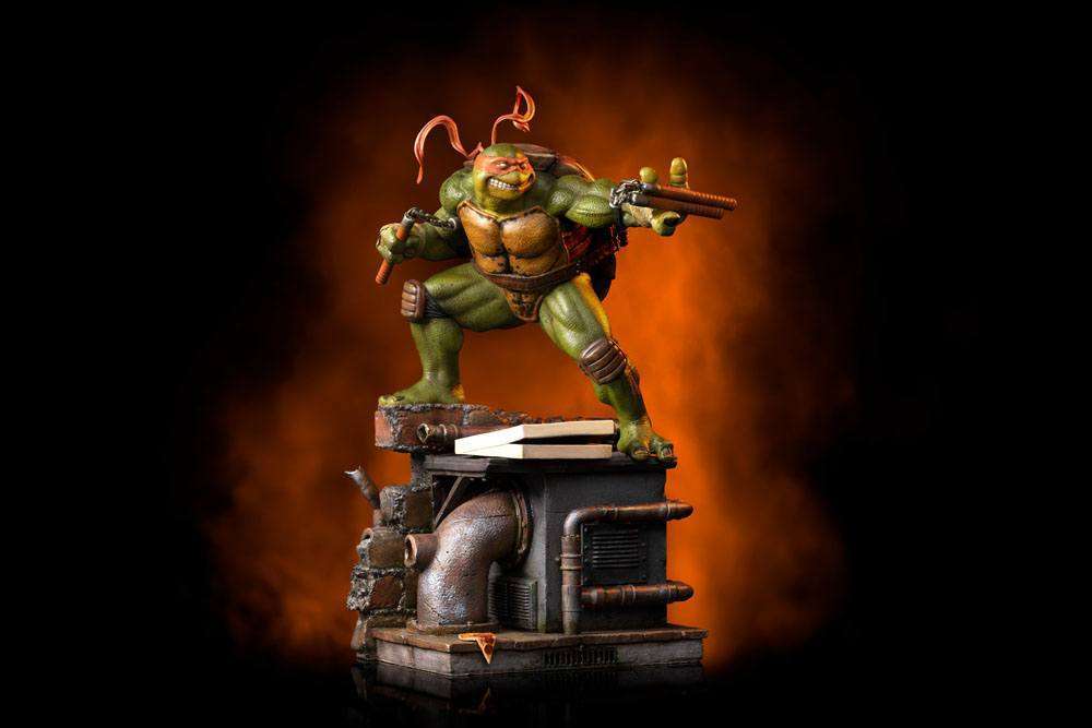 Iron Studios Michelangelo 1/10 scale statue in a dynamic pose with nunchucks on a detailed sewer-themed display base.