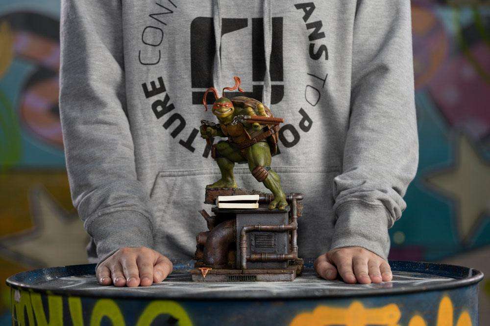 Iron Studios Michelangelo 1/10 scale statue featuring the turtle with nunchucks on a detailed industrial sewer base.