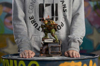 Iron Studios Michelangelo 1/10 scale statue featuring the turtle with nunchucks on a detailed industrial sewer base.