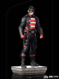 Iron Studios 1/10 John Walker U.S. Agent statue in black tactical suit with red accents, standing on a stone base.