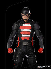 Front view of John Walker U.S. Agent 1/10 scale statue in black and red tactical suit with mask on black background.