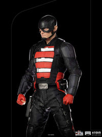 Iron Studios John Walker U.S. Agent 1/10 scale statue in a black and red tactical suit, viewed from the side.