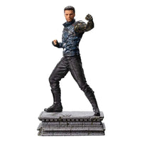 Iron Studios Bucky Barnes 1/10 scale statue in a dynamic fighting pose on a stone base, side view.