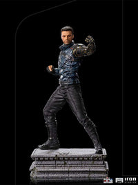 Iron Studios Bucky Barnes 1/10 scale statue in a combat pose, featuring a metallic arm and blue tactical jacket.