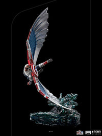 Iron Studios 1/10 Captain America Sam Wilson statue in a dynamic flight pose with detailed wings and water base.