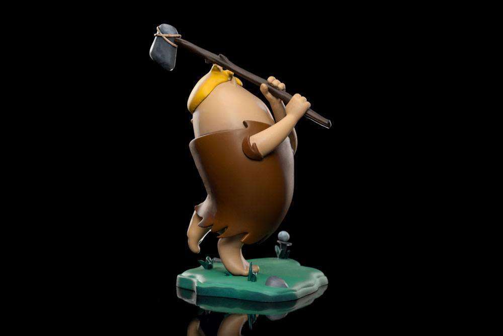 Side view of Iron Studios Barney Rubble 1/10 scale statue holding a stone club on a green base against a black background.