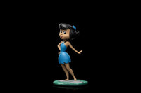Iron Studios 14 cm Betty Rubble statue from The Flintstones in a blue dress, shown from a side angle on a stone base.