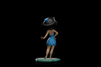 Rear view of Iron Studios 14 cm Betty Rubble statue in a blue dress and black hair, standing on a stone-like base.