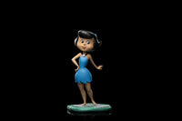 Iron Studios 1/10 scale Betty Rubble statue in a blue dress, standing on a stone base against a black background.