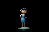 Front view of the 14 cm Iron Studios Betty Rubble statue wearing her signature blue dress on a stone base.