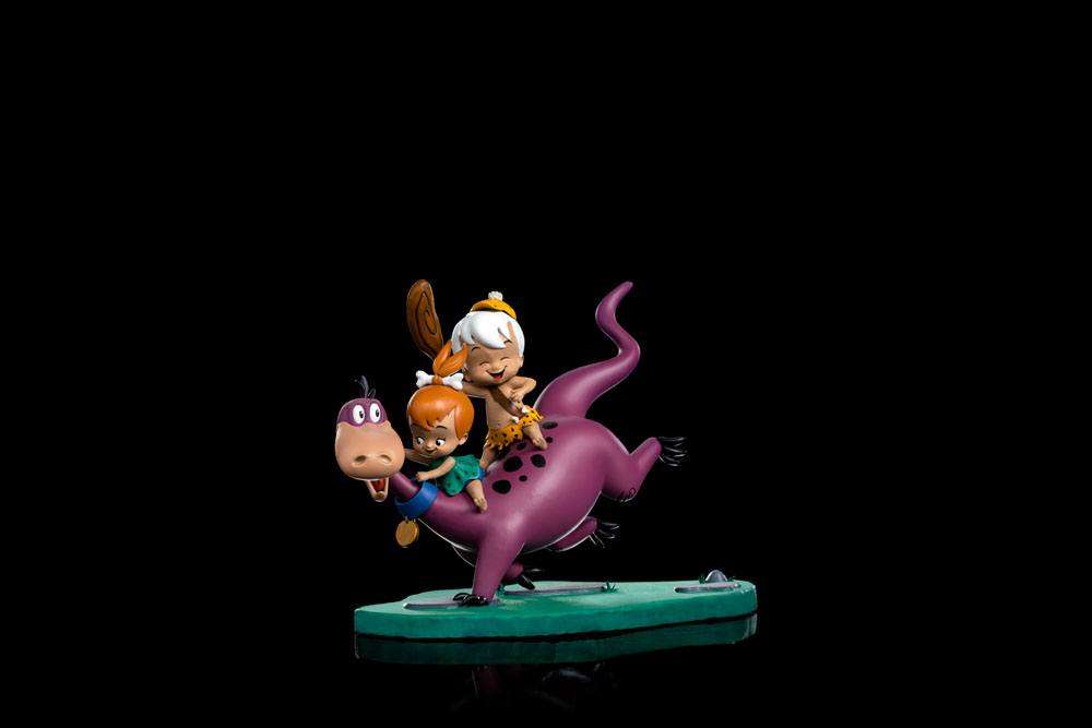 Iron Studios 1/10 scale statue of Dino, Pebbles, and Bamm-Bamm, featuring the colorful characters on a green base.