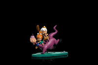Iron Studios 1/10 scale statue of Dino, Pebbles, and Bamm-Bamm, featuring the colorful characters on a green base.