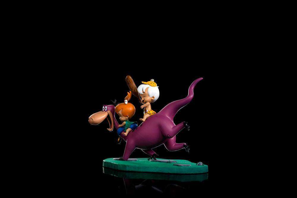 Side view of Iron Studios 1/10 scale Dino, Pebbles and Bamm-Bamm statue featuring vibrant colors on a green base.