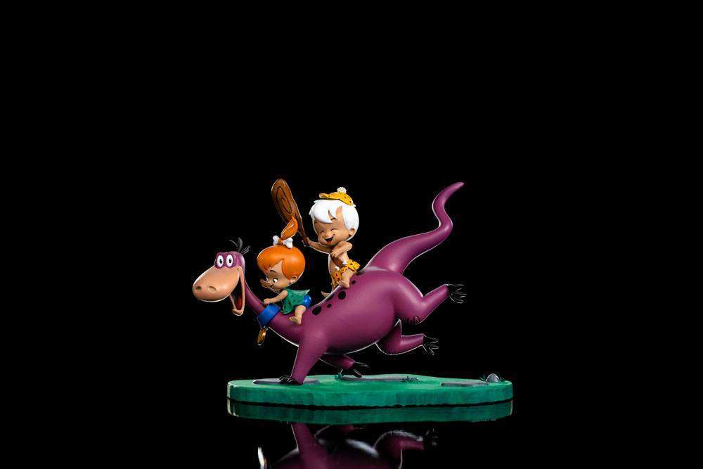 Iron Studios 1/10 scale statue of Dino, Pebbles, and Bamm-Bamm, featuring the trio on a green base, side view.