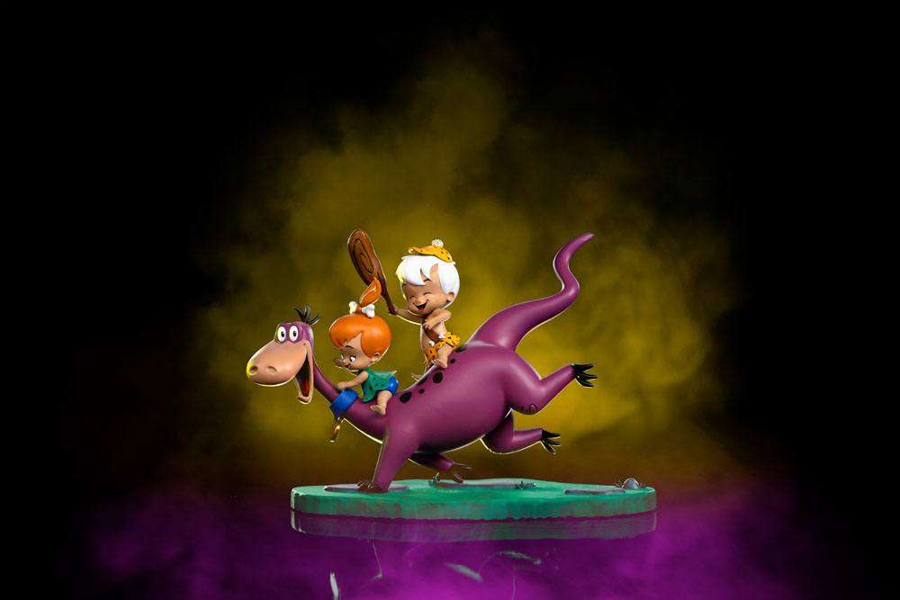 Iron Studios 1/10 scale statue of Dino, Pebbles, and Bamm-Bamm, featuring the colorful characters on a green base.
