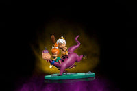 Iron Studios 1/10 scale statue of Dino, Pebbles, and Bamm-Bamm featuring colorful figures on a green base, side view.