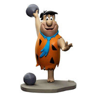 Front view of Iron Studios Fred Flintstone 1/10 scale statue, bowling with a grey ball on a stone-textured base.