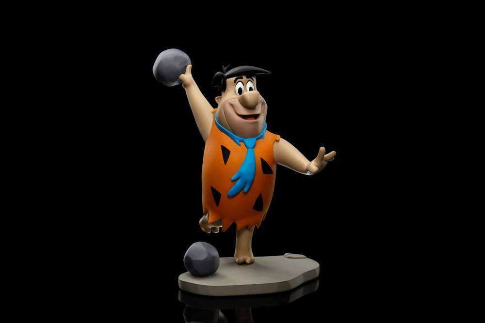 Iron Studios 1/10 scale Fred Flintstone statue in a bowling pose, wearing his signature orange tunic with black spots.