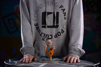 Iron Studios 1/10 scale Fred Flintstone statue standing on a circular base, shown from a front-facing perspective.