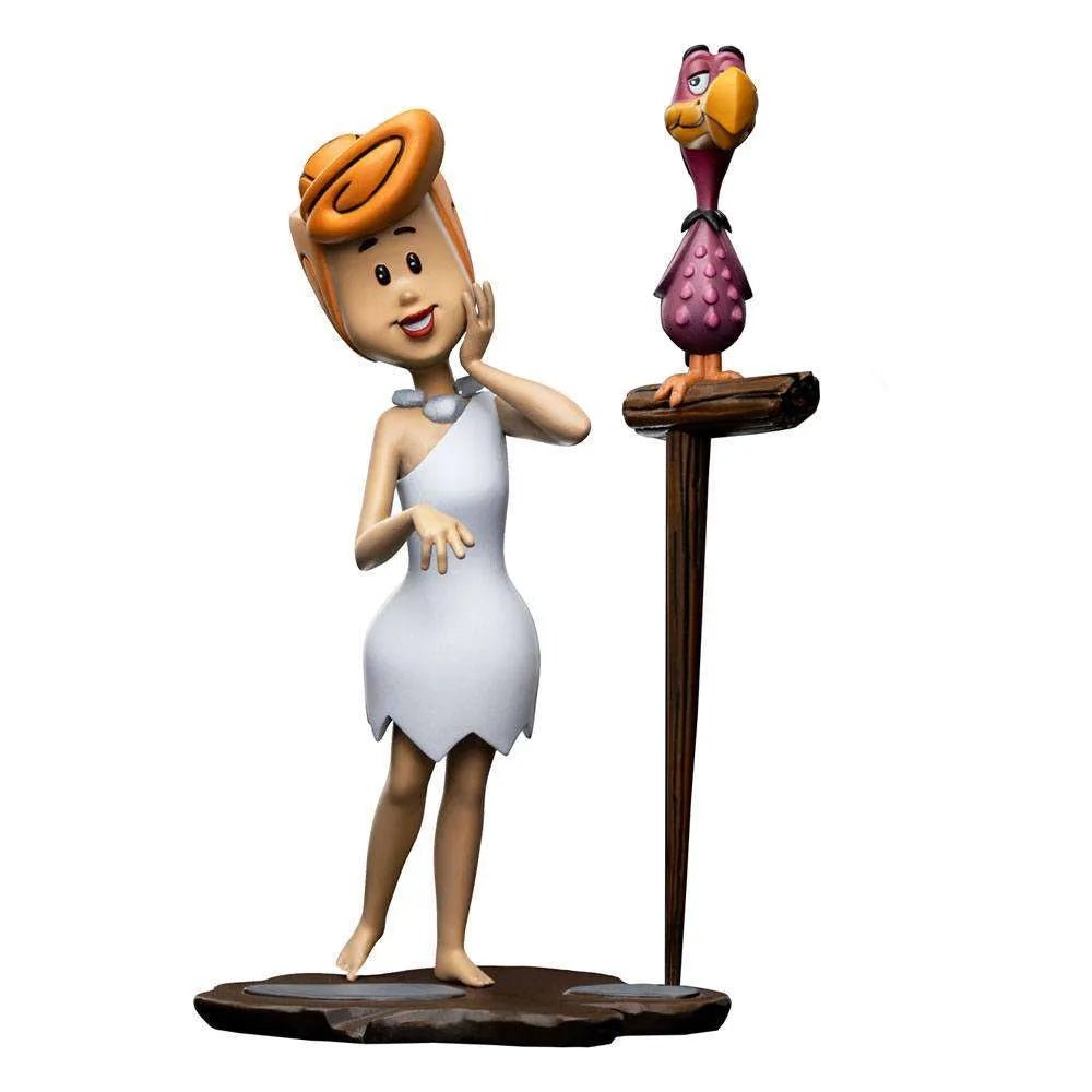 Iron Studios Wilma Flintstone 1/10 scale statue in a white dress standing next to a purple bird on a wooden perch.