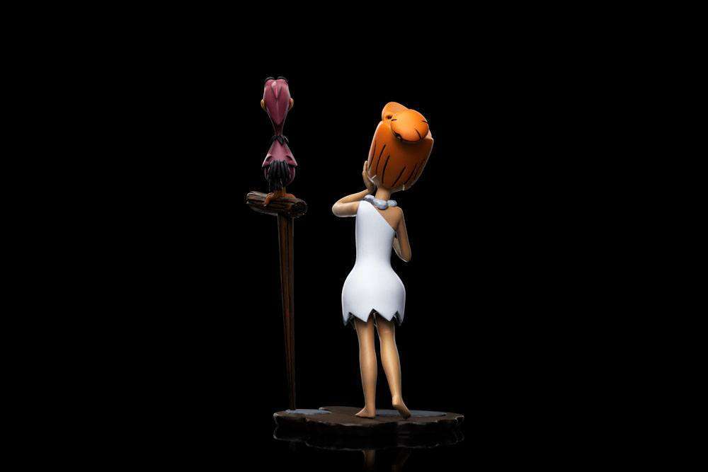 Back view of the 16cm Iron Studios Wilma Flintstone Art Scale statue standing with a bird on a wooden perch.