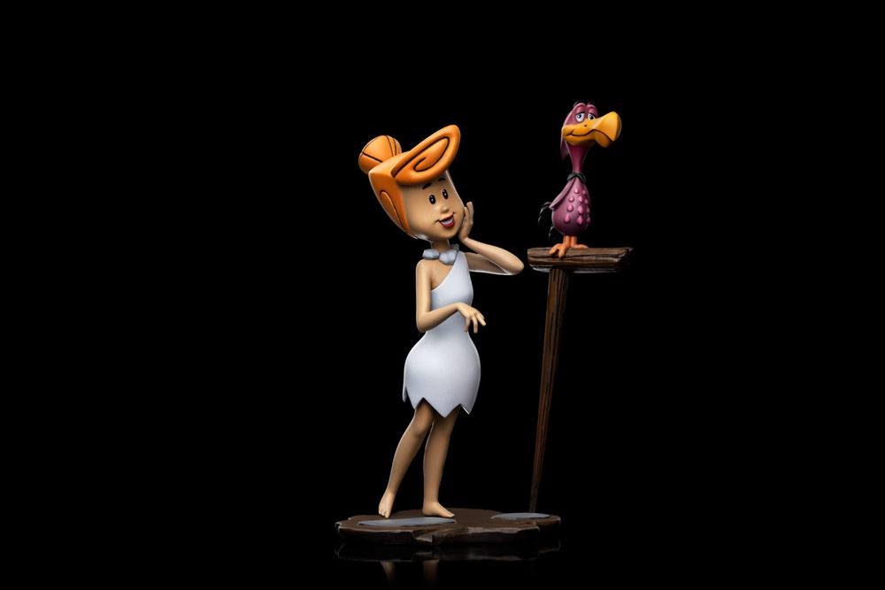 Iron Studios 1/10 Wilma Flintstone statue featuring Wilma in her white dress with a bird on a perch, side view.