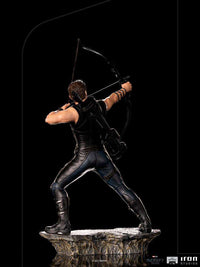 Back view of Iron Studios Hawkeye 1/10 scale statue aiming a bow while standing on a rocky Battle of NY base.