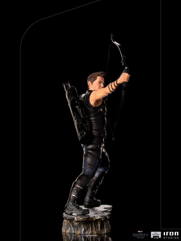 Side view of Iron Studios Hawkeye 1/10 scale statue in black tactical gear, aiming his bow on a rocky base.