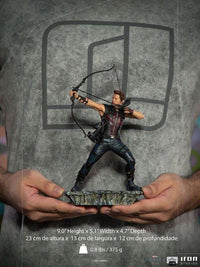 Iron Studios 1/10 Hawkeye Battle of NY statue in a dynamic archery pose, held in hands against a grey background.