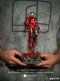 Iron Studios 1/10 Iron Man Battle of NY statue in red and gold armor hovering over a rocky, fiery base.